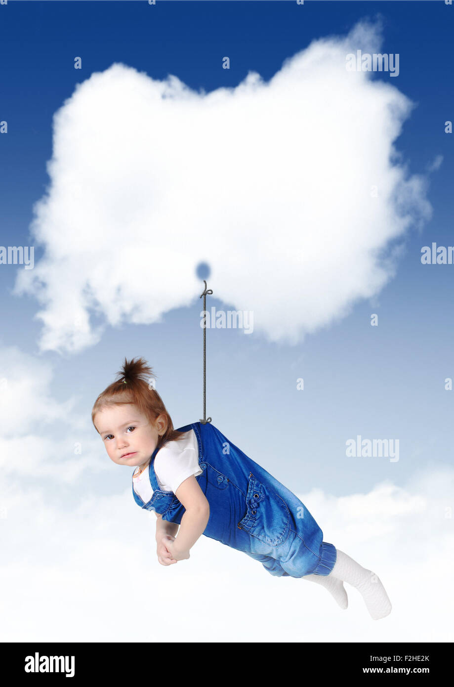 sad baby flying on a cloud with copy space Stock Photo
