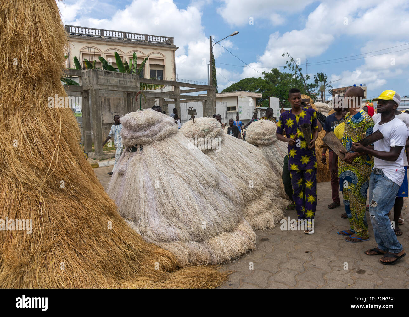 Benin, West Africa, Porto-Novo, men guiding zangbeto guardians of the night spirits in the street Stock Photo