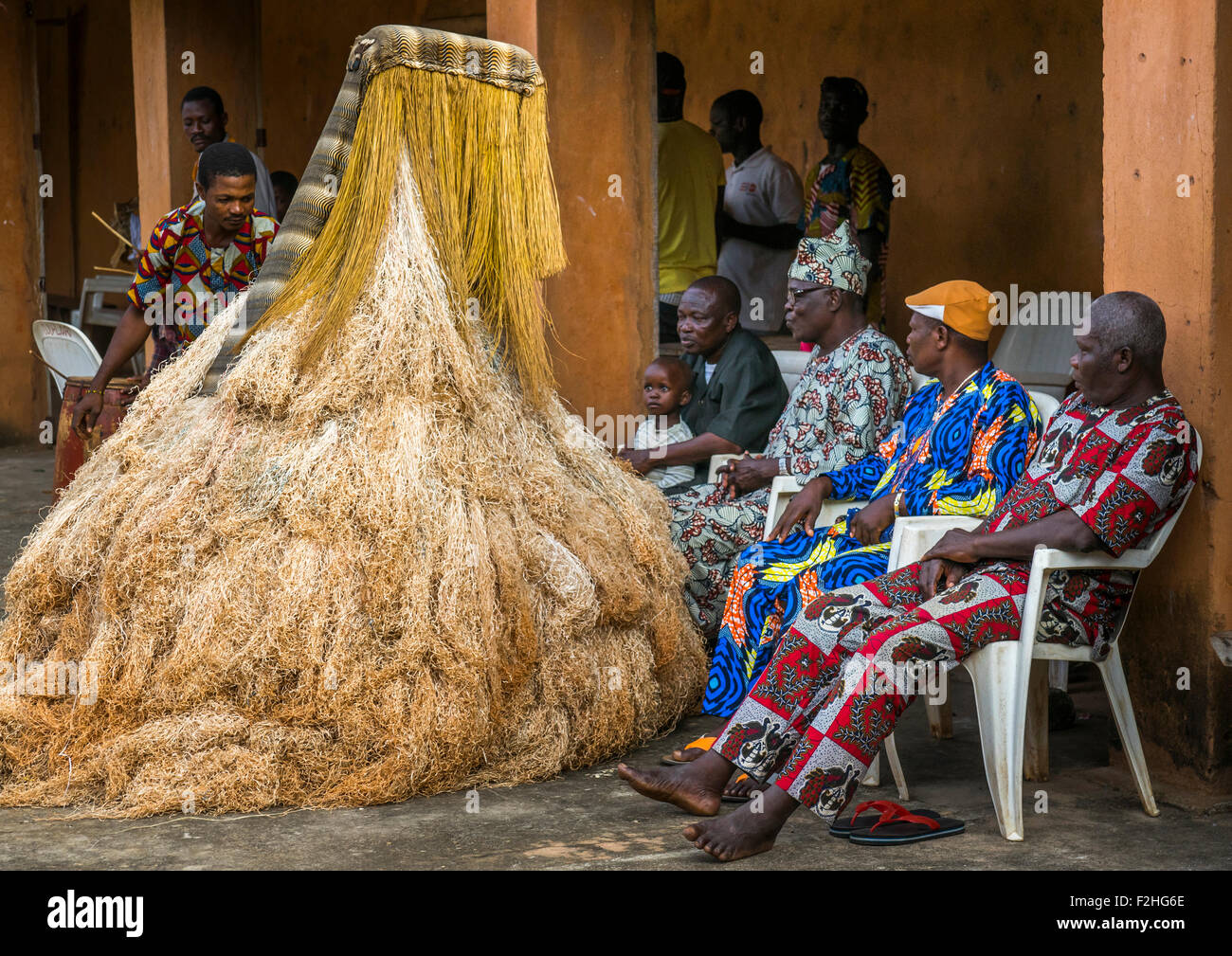 Benin, West Africa, Porto-Novo, men speaking to a zangbeto guardian of the night spirit in the royal palace Stock Photo