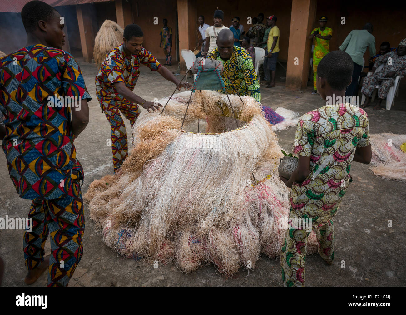 Benin, West Africa, Porto-Novo, men showing there is nobody inside the zangbeto guardian of the night in the royal palace Stock Photo