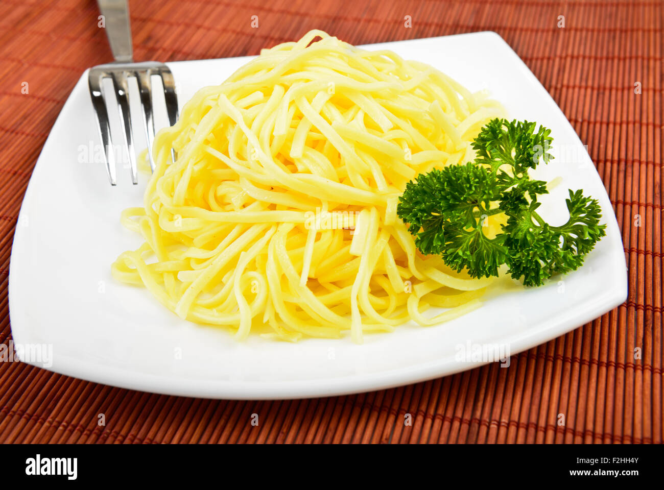 spaghetti pasta on plate with fork Stock Photo
