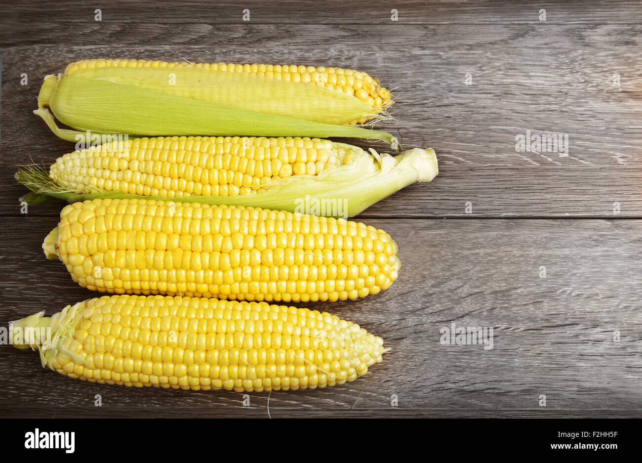 Corn cobs on wooden table Stock Photo Alamy