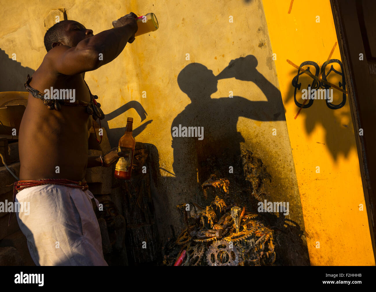 Benin West Africa Bonhicon Kagbanon Bebe Voodoo Priest Drinking Orange Juice And Spitting It On Ogun God Altar Made With Pedaliers Biking Stock Photo Alamy