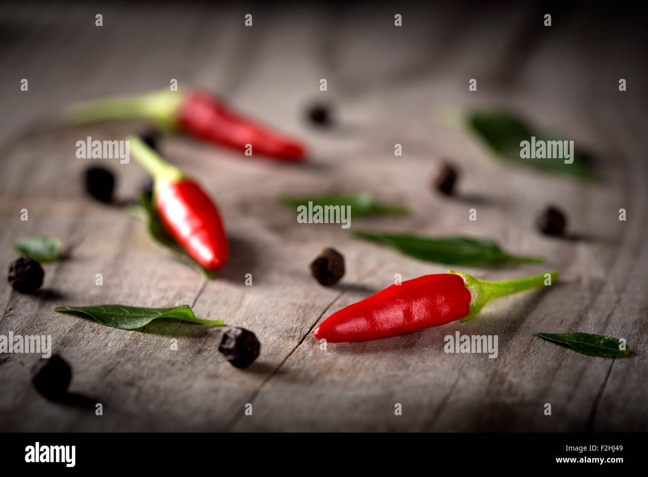 Red hot chili peppers on wood background with black pepper Stock Photo ...