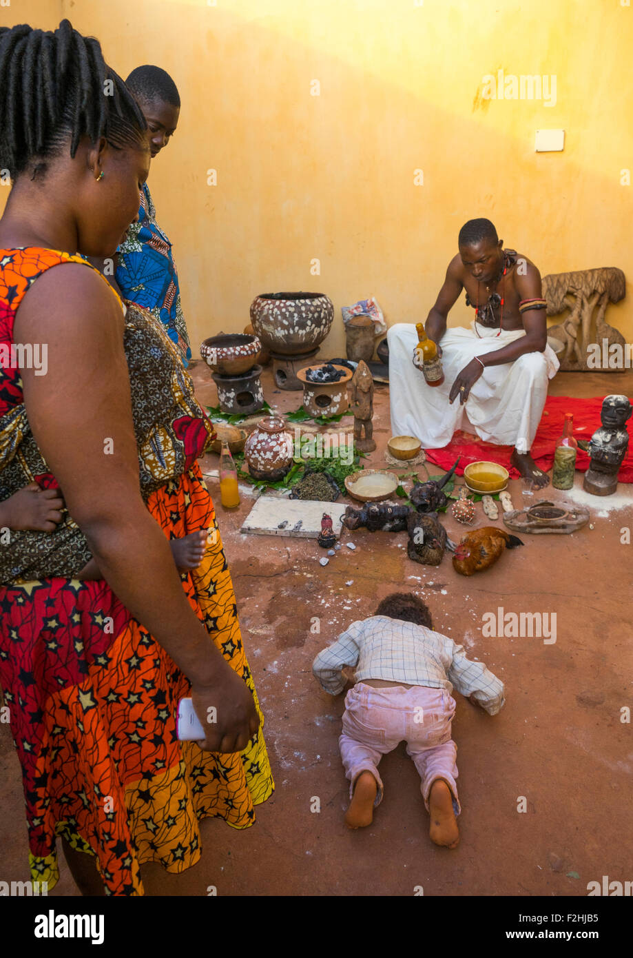 Benin, West Africa, Bonhicon, a child bowing in front of kagbanon bebe voodoo priest during a ceremony Stock Photo