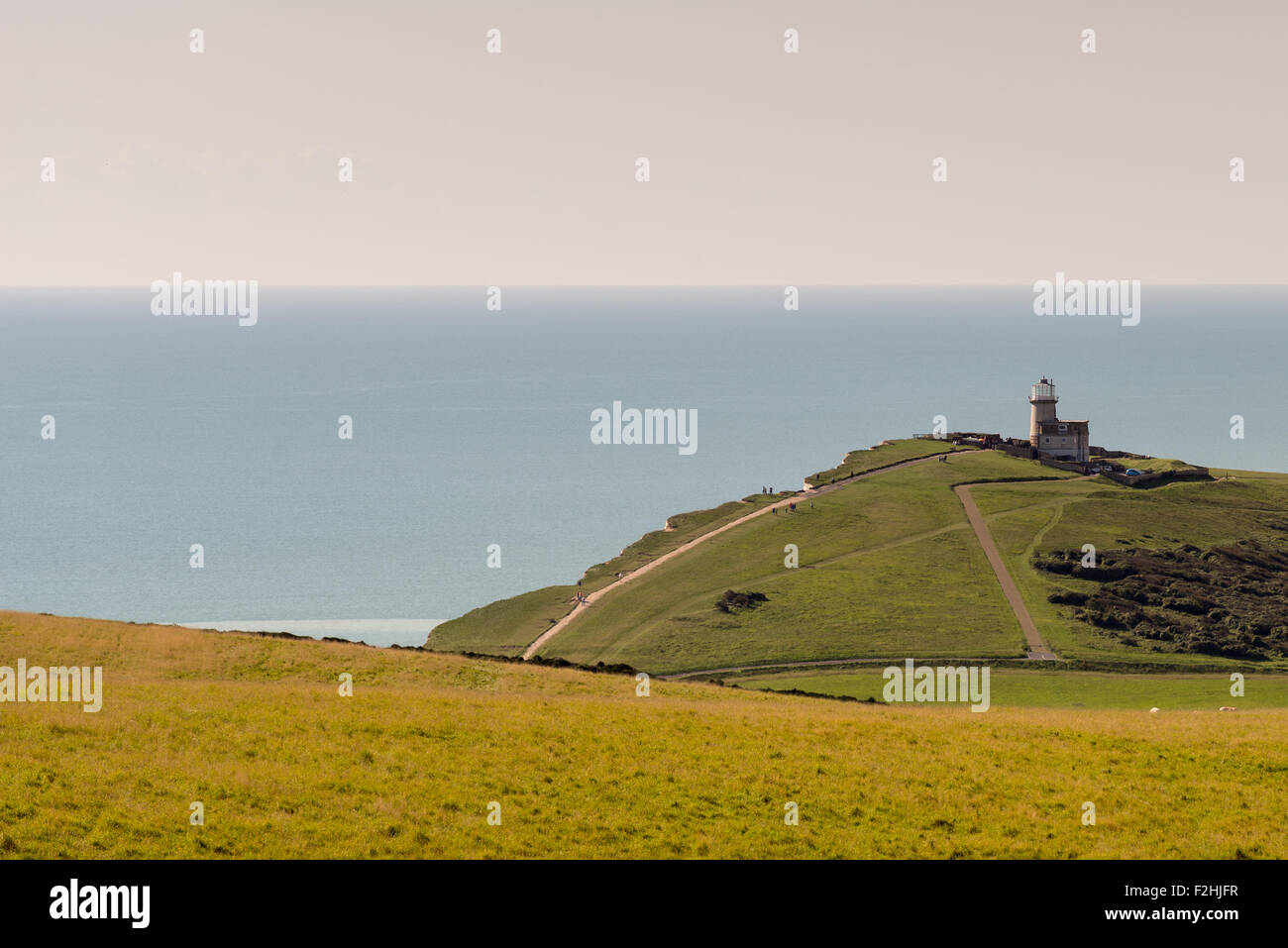 Beachy Head towards Birling Gap and the Belle Tout lighthouse on a clear, sunny, autumnal day.  Beachy Head is a popular tourist destination. Stock Photo