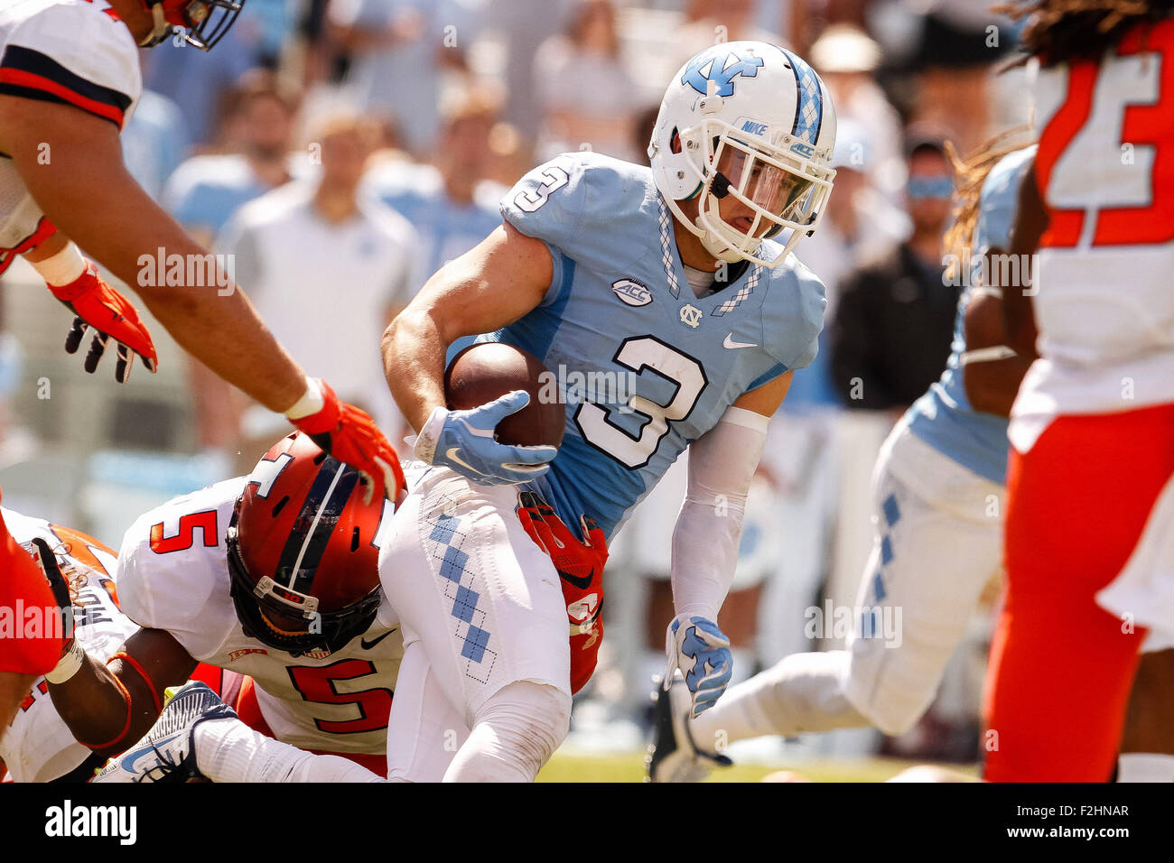 Chapel Hill, NC, USA. 19th Sep, 2015. Ryan Switzer (3) of the North Carolina Tar Heels gets tied up on this punt return by James Crawford (5) of the Illinois Fighting Illini in the NCAA football matchup between the Fighting Illini of Illinois and the North Carolina Tarheels at Kenan Memorial Stadium in Chapel Hill, NC. Scott Kinser/CSM/Alamy Live News Stock Photo