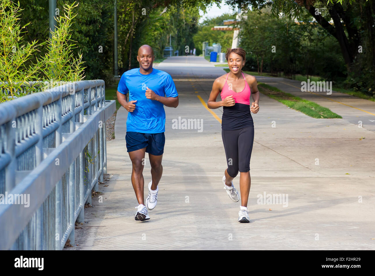 Young African-American black man jogging and running on a path and