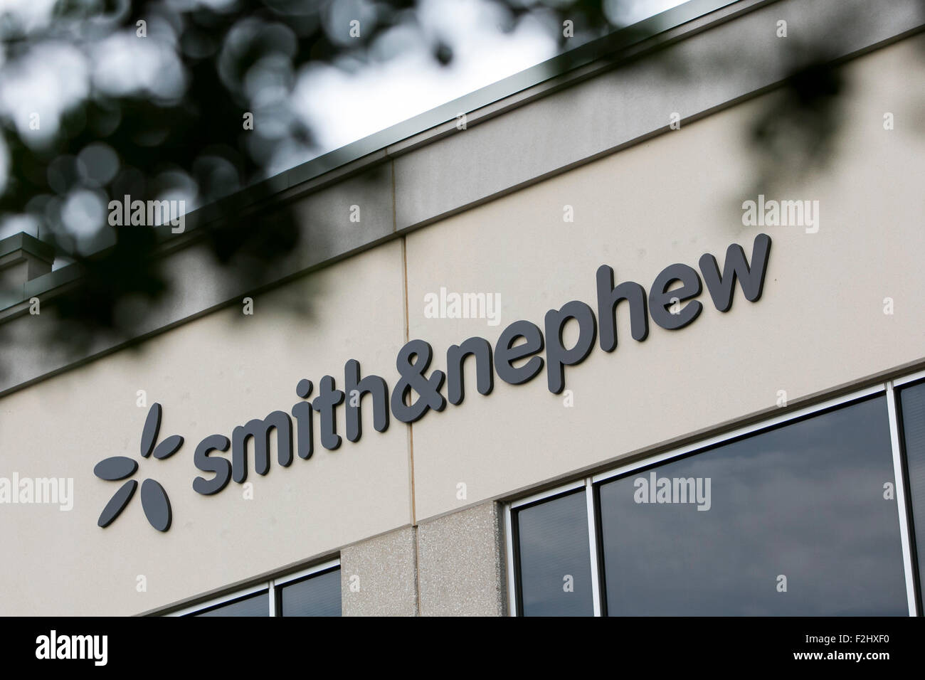 A logo sign outside of a facility occupied by Smith & Nephew in Austin