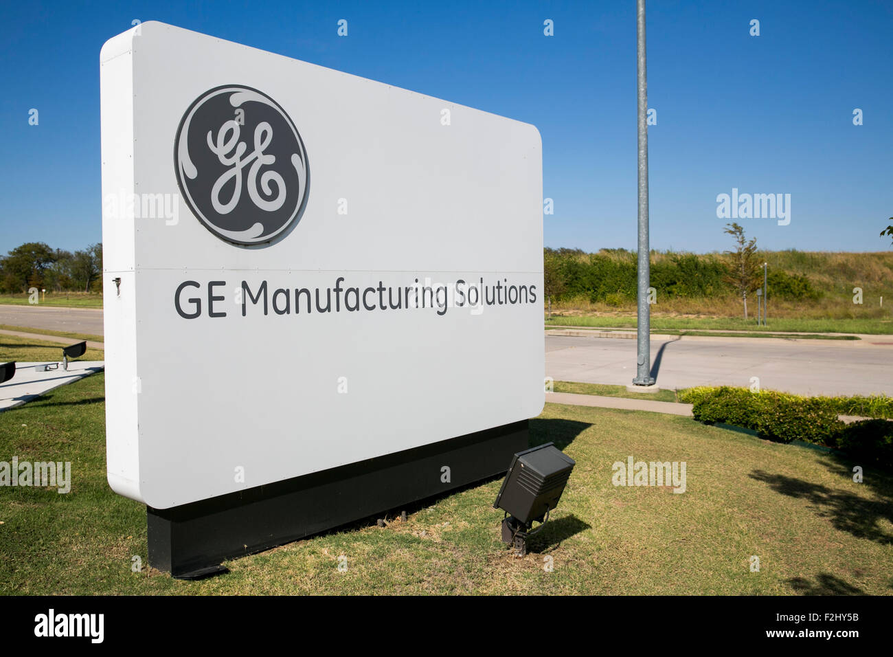 A logo sign outside of a facility occupied by GE (General Electric) Manufacturing Solutions in