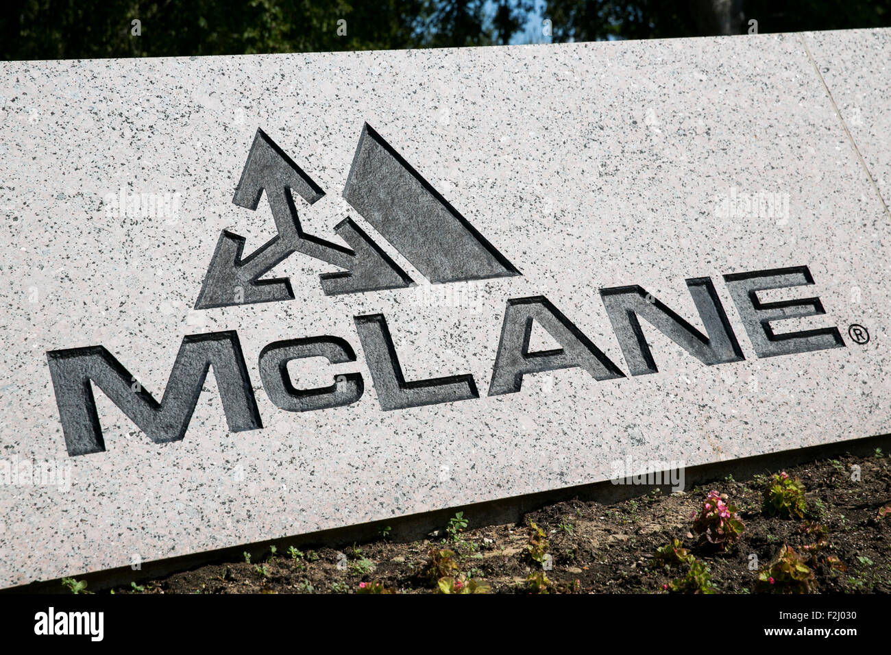 A logo sign outside of the headquarters of the McLane Company in Temple