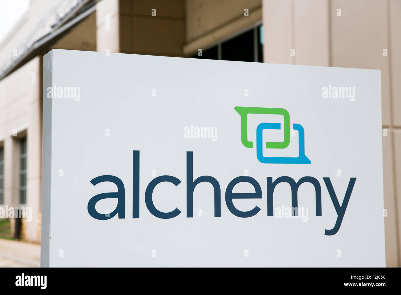 A logo sign outside of the headquarters of Alchemy Systems, LP, in Austin, Texas on September 11, 2015. Stock Photo