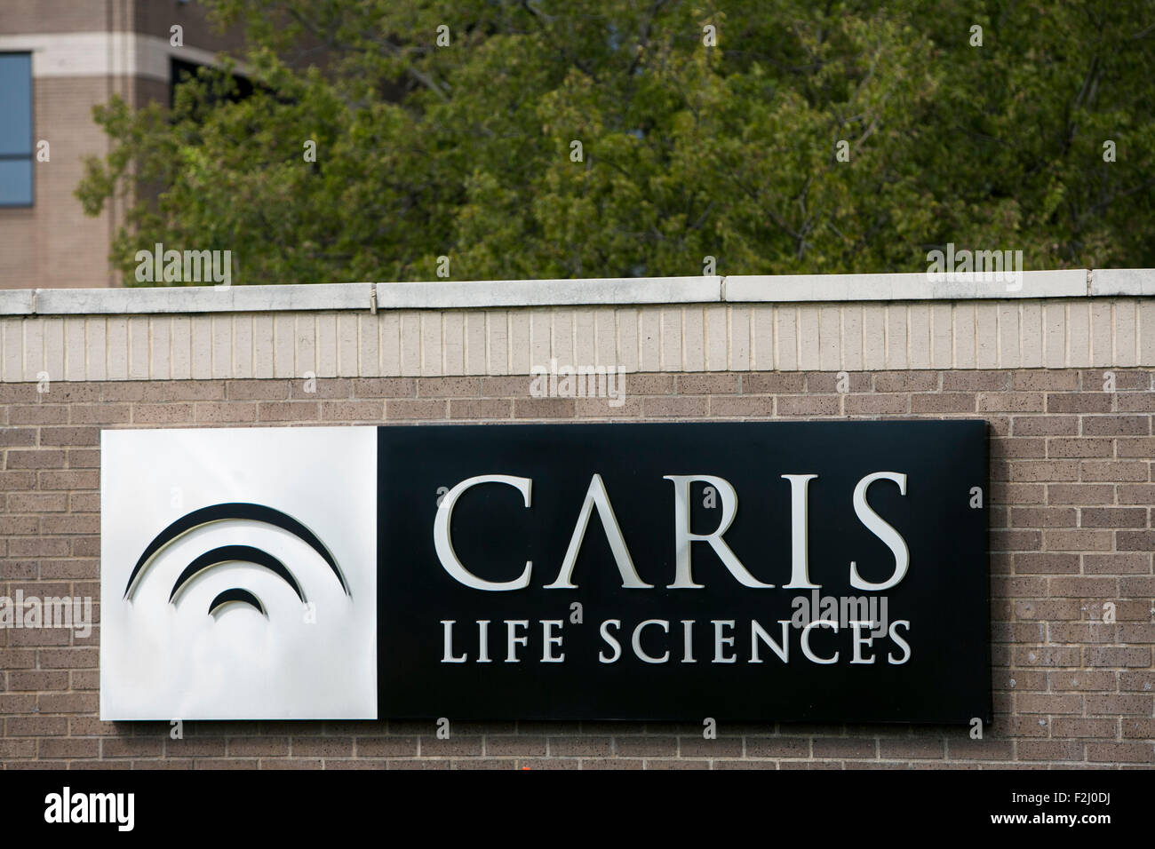 A logo sign outside of the headquarters of Caris Life Sciences in