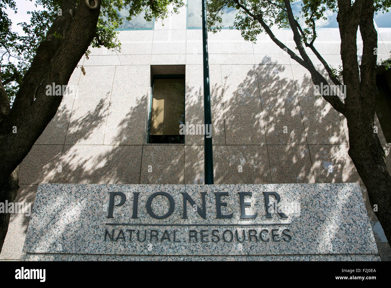 A logo sign outside of the headquarters of the Pioneer Natural Resources Co., in Irving, Texas on September 13, 2015. Stock Photo