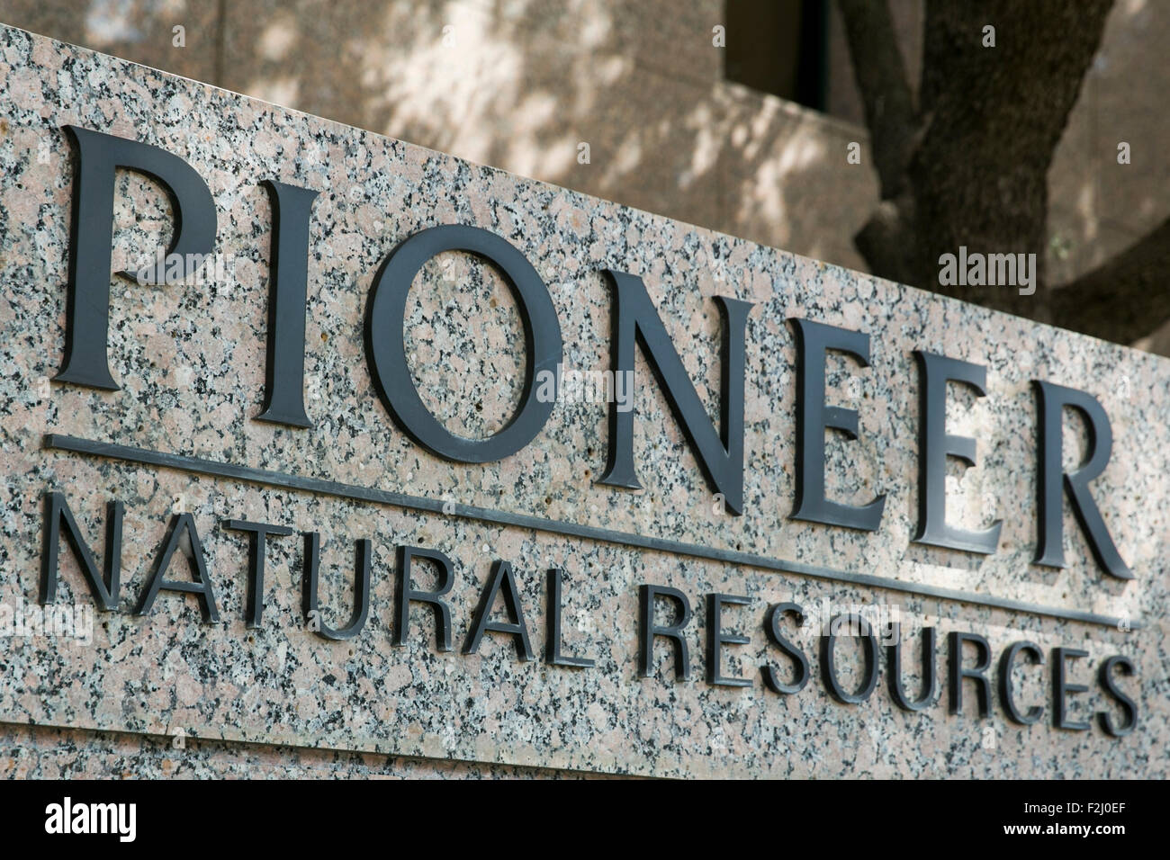 A logo sign outside of the headquarters of the Pioneer Natural Resources Co., in Irving, Texas on September 13, 2015. Stock Photo