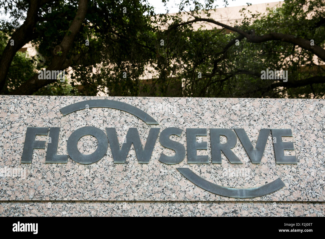 A logo sign outside of the headquarters of The Flowserve Corporation in