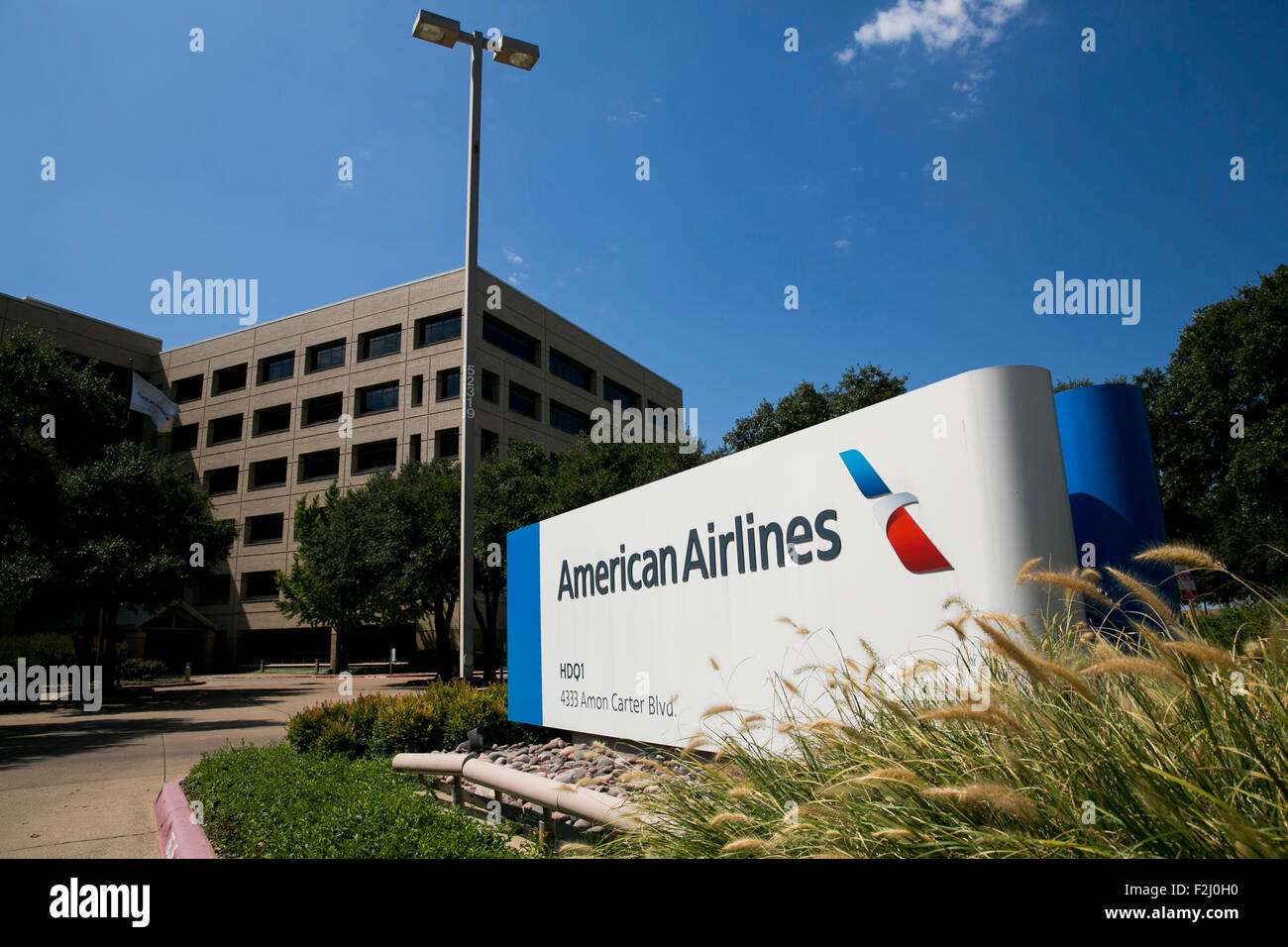 A logo sign outside of the headquarters of American Airlines, Inc., in