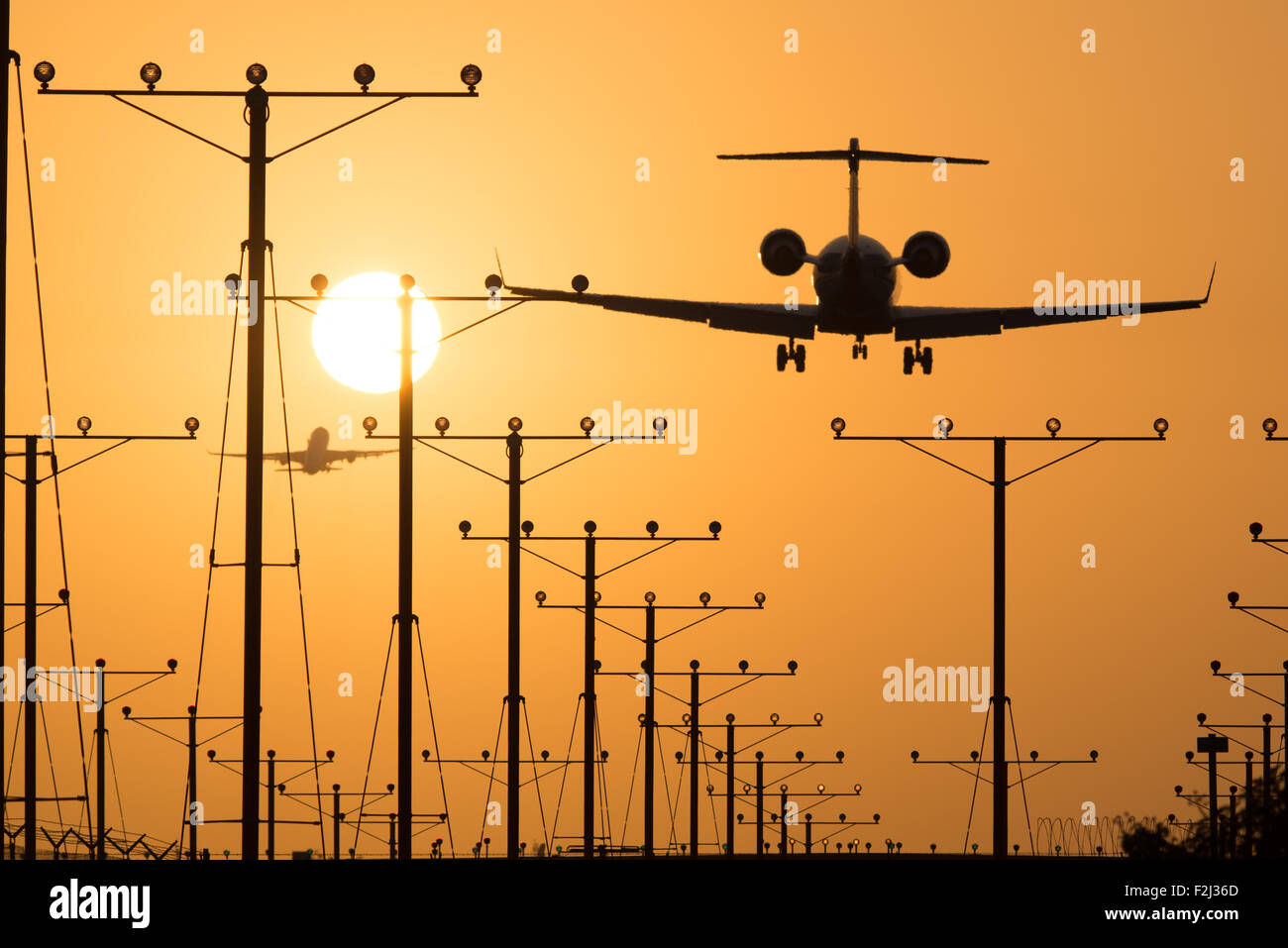 Airplane landing at Los Angeles International Airport during sunset, Los Angeles, California, USA Stock Photo