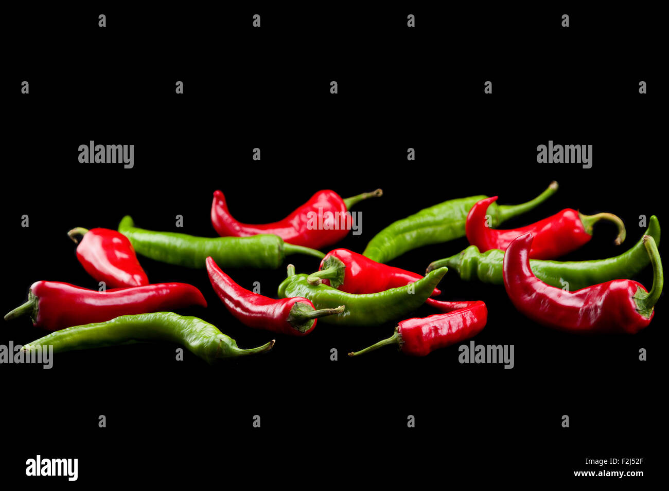 Red and green chili pepper isolated on black Stock Photo