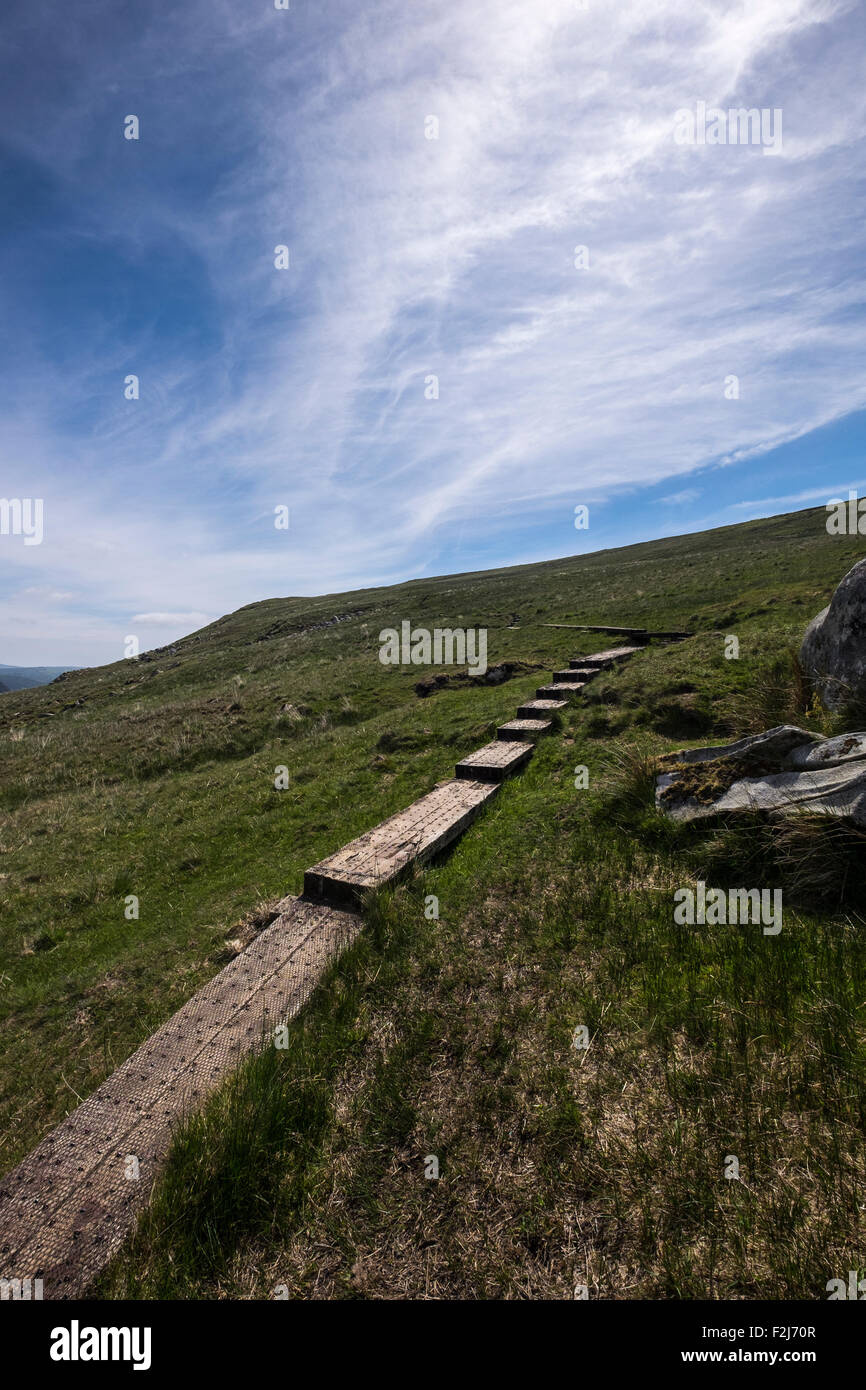 Walking in Glendalough, County Wicklow, Ireland. Path over the Spinc with views over the valley and lakes. Stock Photo