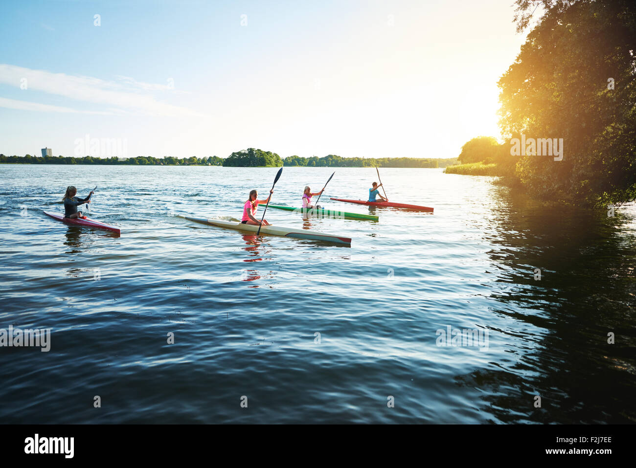 Team of sports kayaks racing on the lake Stock Photo