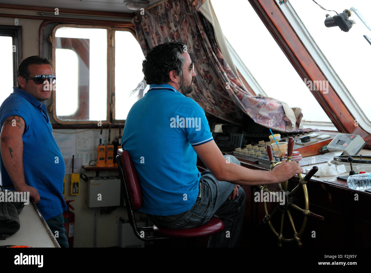 Captain steers the Nikolaos, Rhodes to Symi ferry Stock Photo Alamy