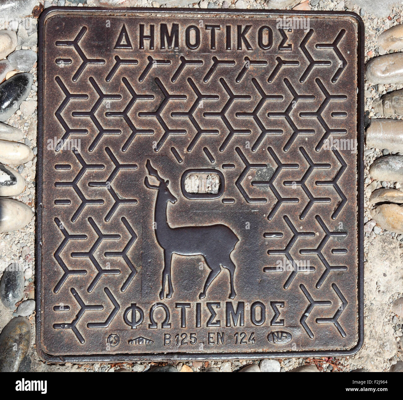 Rhodes drain cover showing the deer, symbol of Rhodes Stock Photo