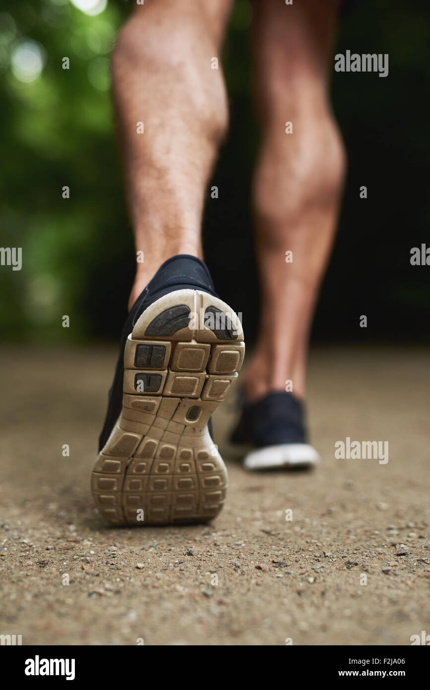 Close up Shoe Sole of an Athletic Young Man Running at the Park Stock