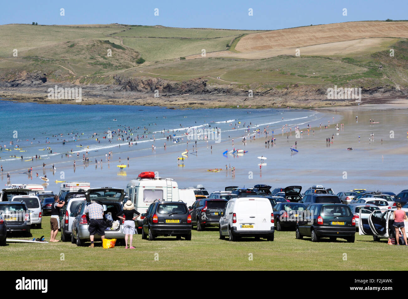 North Cornwall - Polzeath cliff top parking - popular location - view to beach and  Pentire Point - brilliant summer sunlight Stock Photo