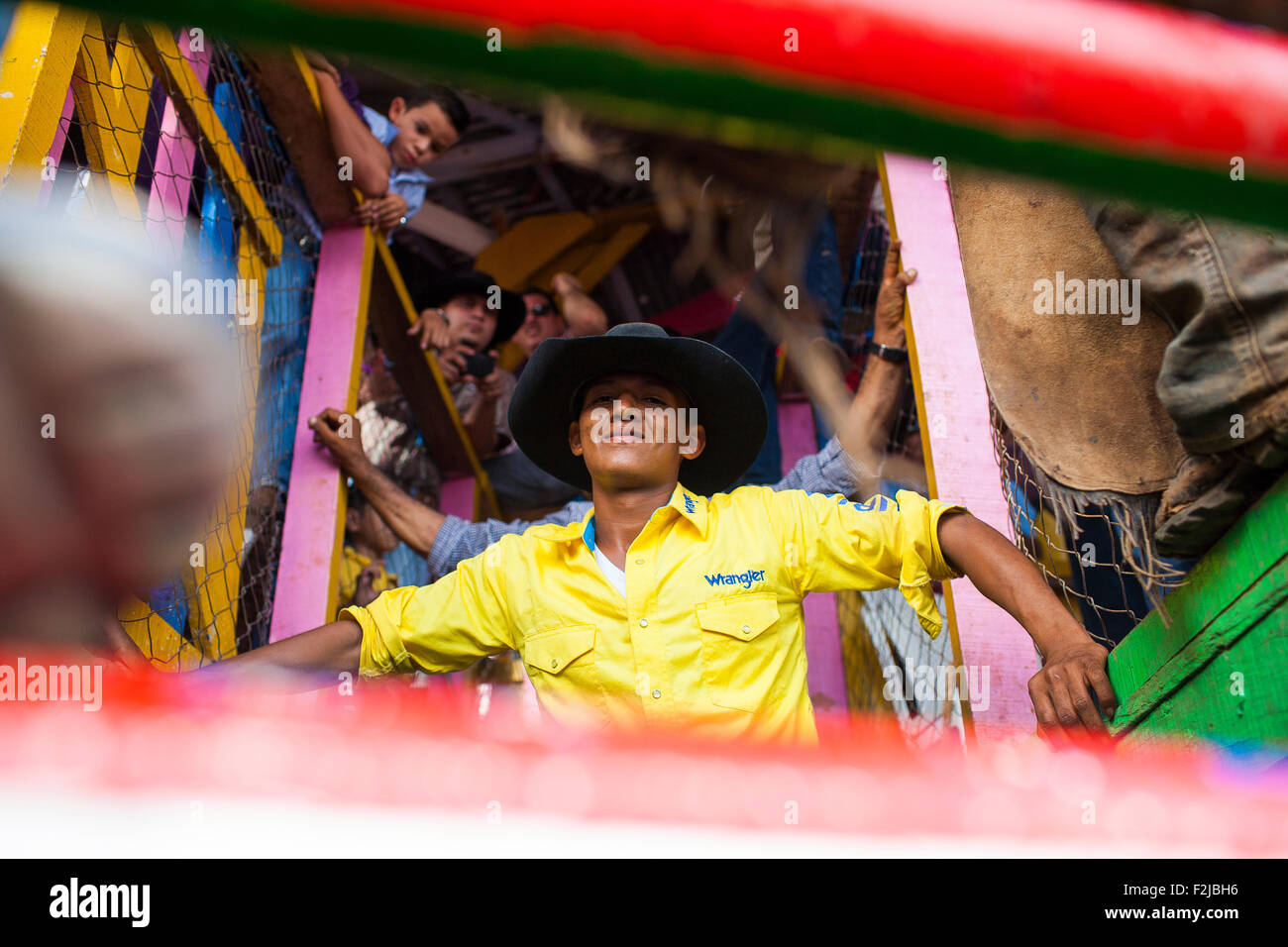 The rider prepares to be released during the annual fiesta in Juigalpa, Nicaragua. The crowd cheers and encourages his machismo. Stock Photo