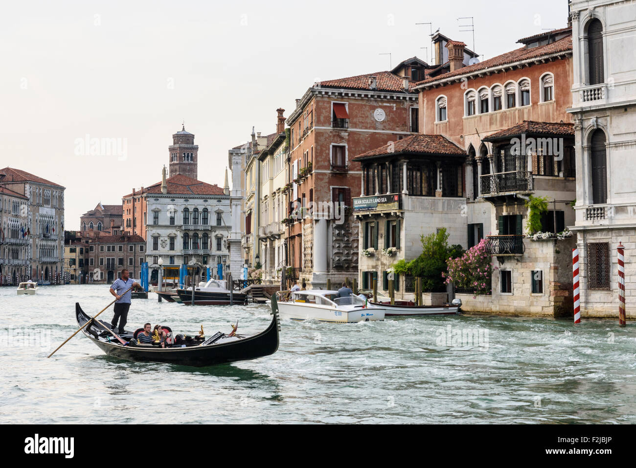 Tourists in a gondola on the Grand Canal in Venice, Veneto, Italy Stock Photo