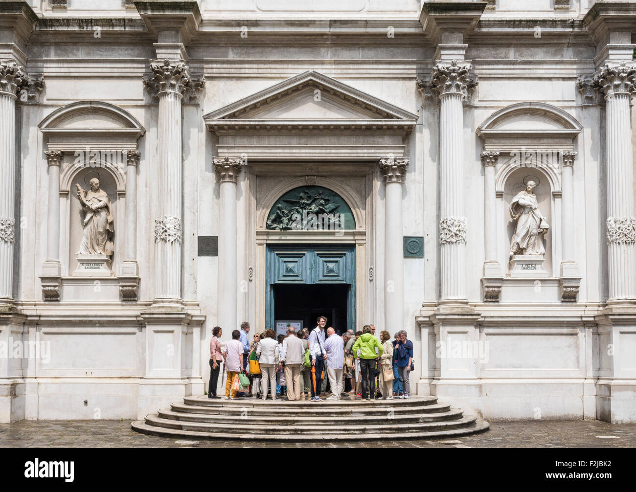 People gathered outside the Church of Saint Roch, Campo San Rocco, San Polo, Venice, Italy Stock Photo