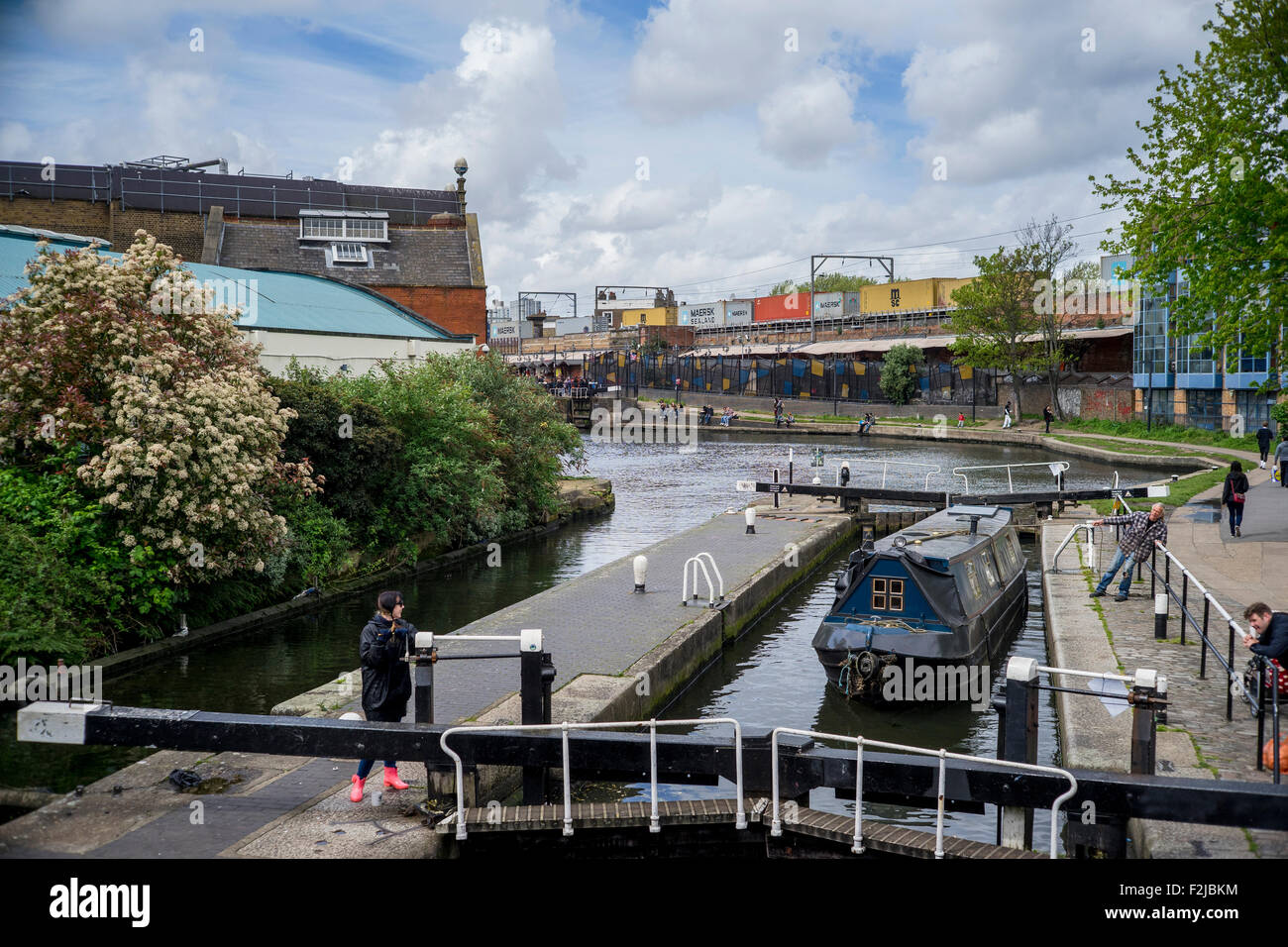 Lock gates and canal boat on Regent's Canal near Camden Lock and Market in London England near MTV Viacom studios Stock Photo