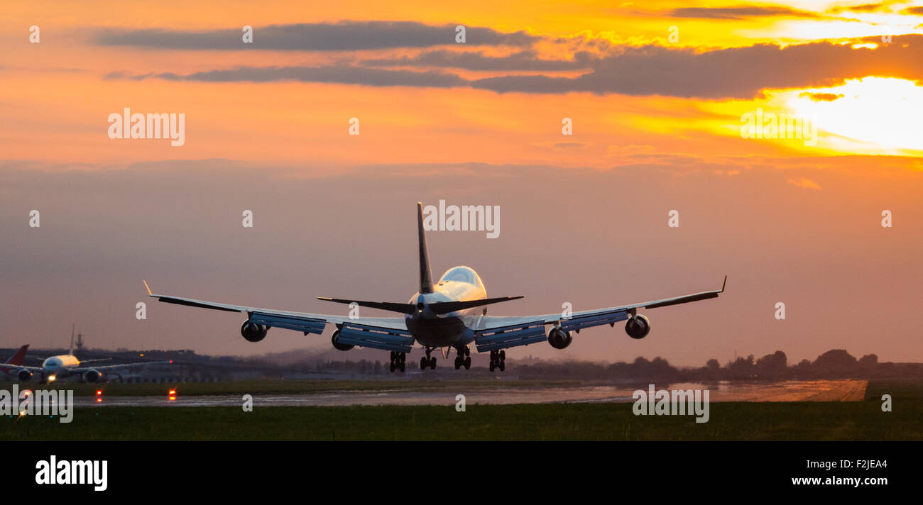 London Heathrow, September 19th 2015. As the setting sun lights up the sky in a feiry display, a Cathay Pacific Cargo Boeing 747 Freighter lands on Heathrow Airport's Runway 27R. Credit:  Paul Davey/Alamy Live News Stock Photo