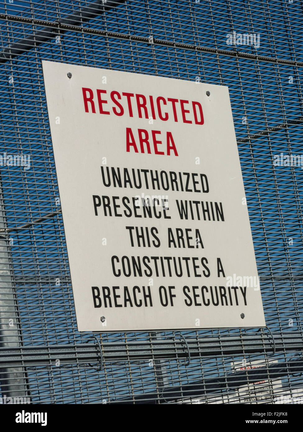 Restricted Area Sign on Metal Fence Stock Photo