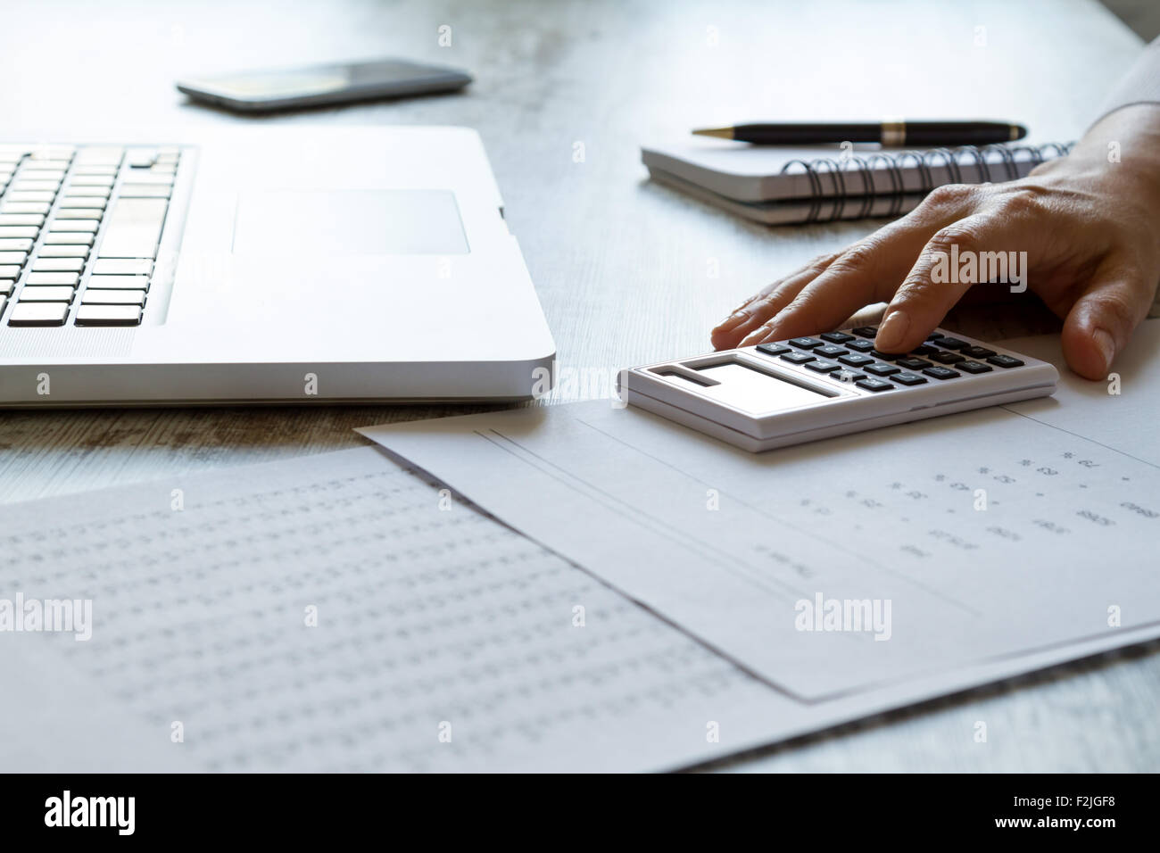 Analyzing numbers and doing calculations at the office Stock Photo