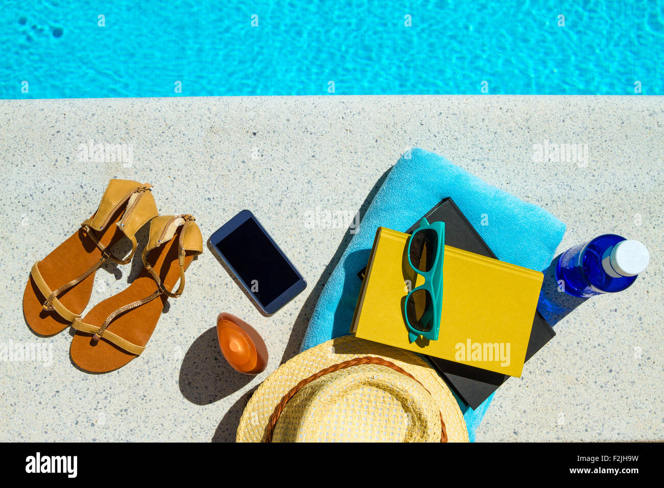 Reading near the swimming pool Stock Photo Alamy