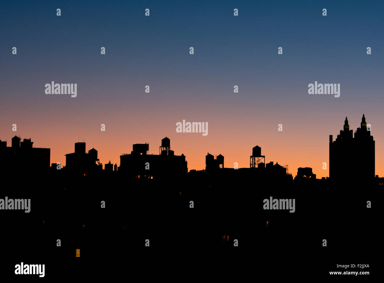 A silhouetted view of the Manhattan skyline and El Dorado building on the Upper West Side at sunrise;  New York City Stock Photo