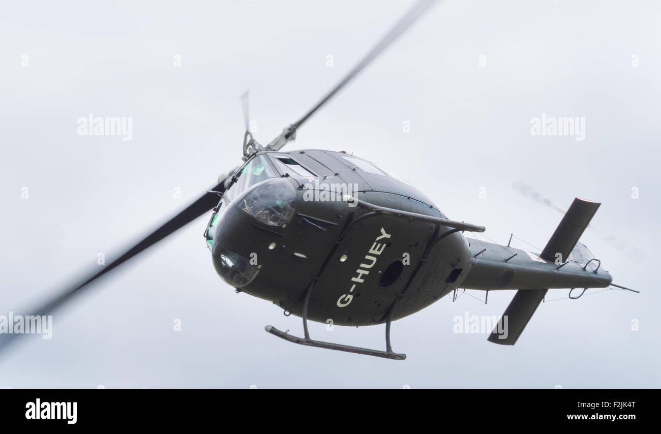 Yeovilton, UK - 11th July 2015: Vintage Bell 'Huey' helicopter flying at Yeovilton Air Day. Stock Photo