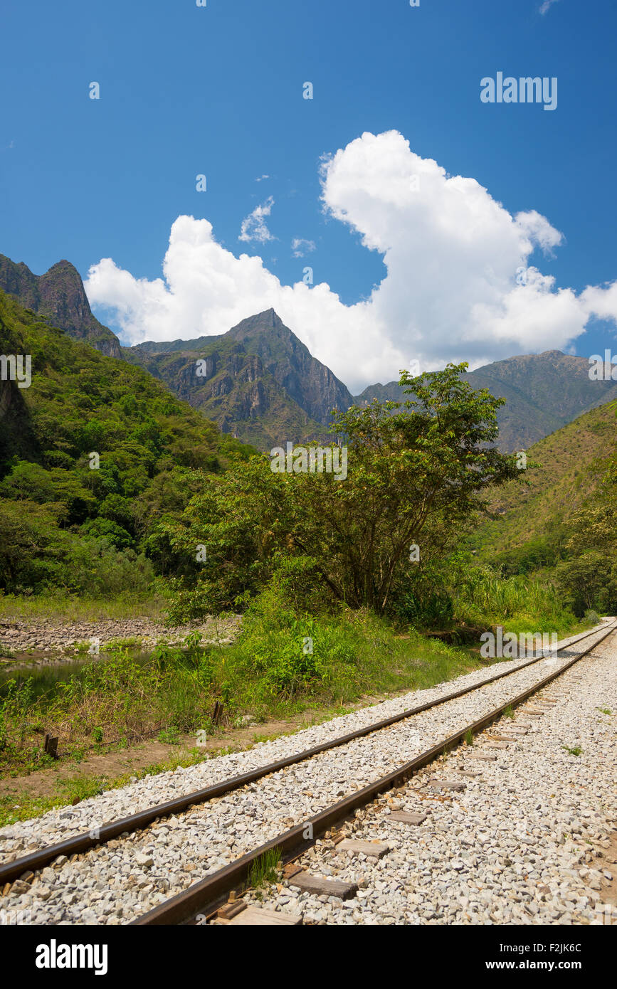 The railroad track crossing jungle and Urubamba river, connecting Machu Picchu village to hydroelectric station, mostly used for Stock Photo