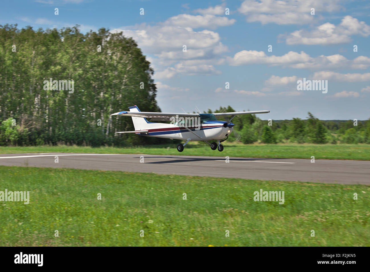 Private plane landing on a small airfield Stock Photo