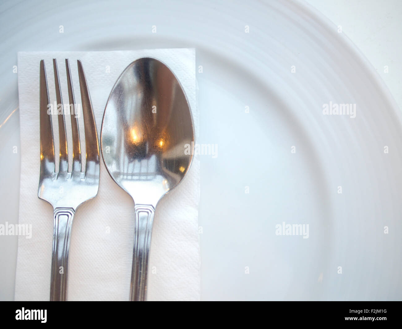 spoon and fork on plate Stock Photo