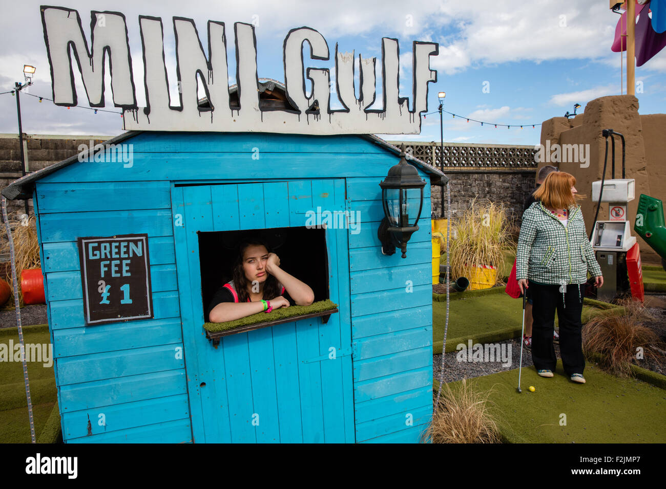 Picture of ennui in the pay booth of the Mini Gulf course at Dismaland - Banksy's theme park attraction in Weston super Mare Stock Photo