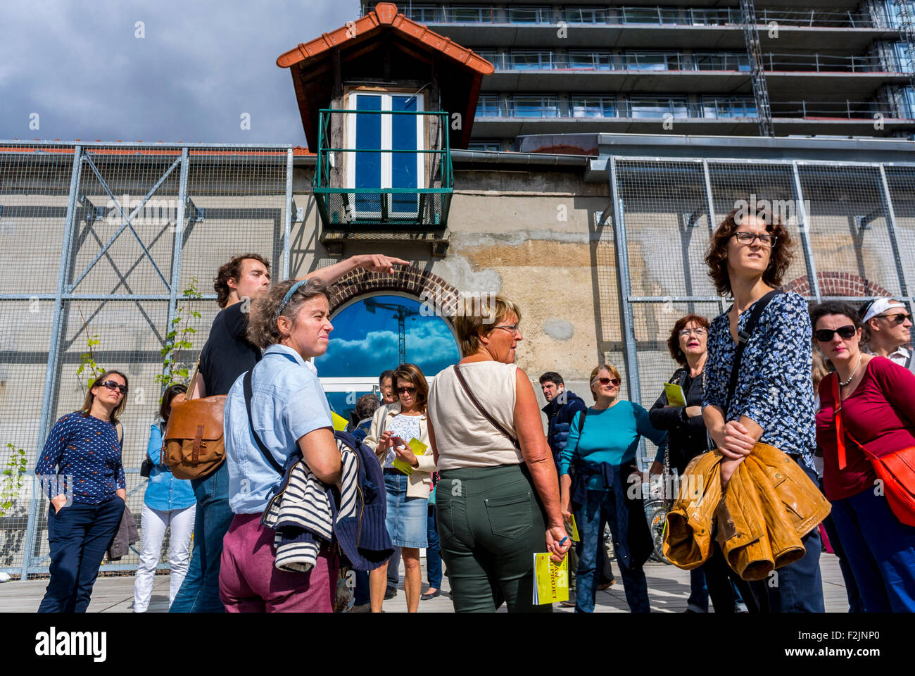 Paris France Tour Guide Leading Groups Speaking To Group Of Tourists Visiting New Modern