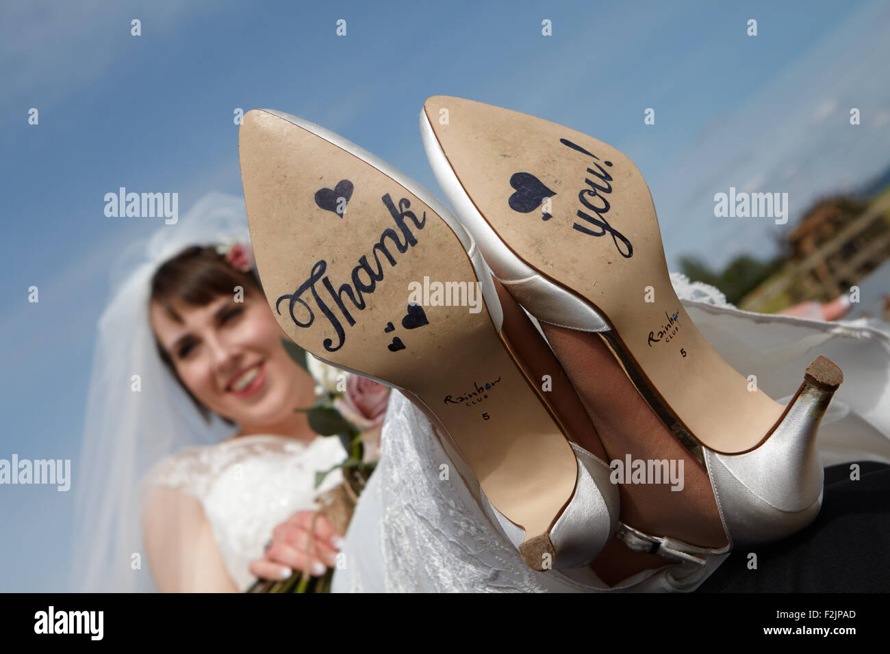 Bride with thank you written on shoes Stock Photo