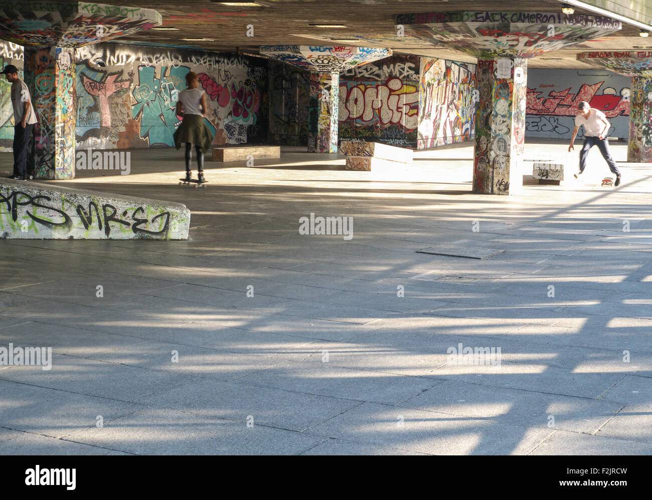 Graffiti in skate park with skateboarders Stock Photo Alamy