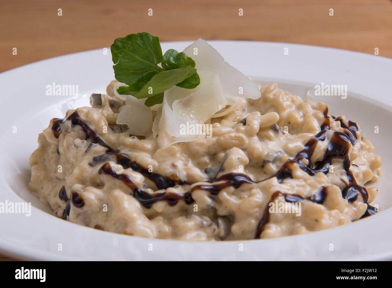 Mushroom risotto served with balsamic vinegar. Stock Photo