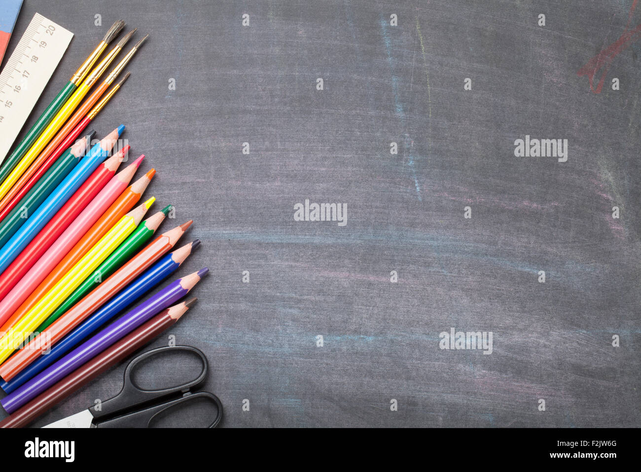 School and office supplies on blackboard background. Top view with copy ...