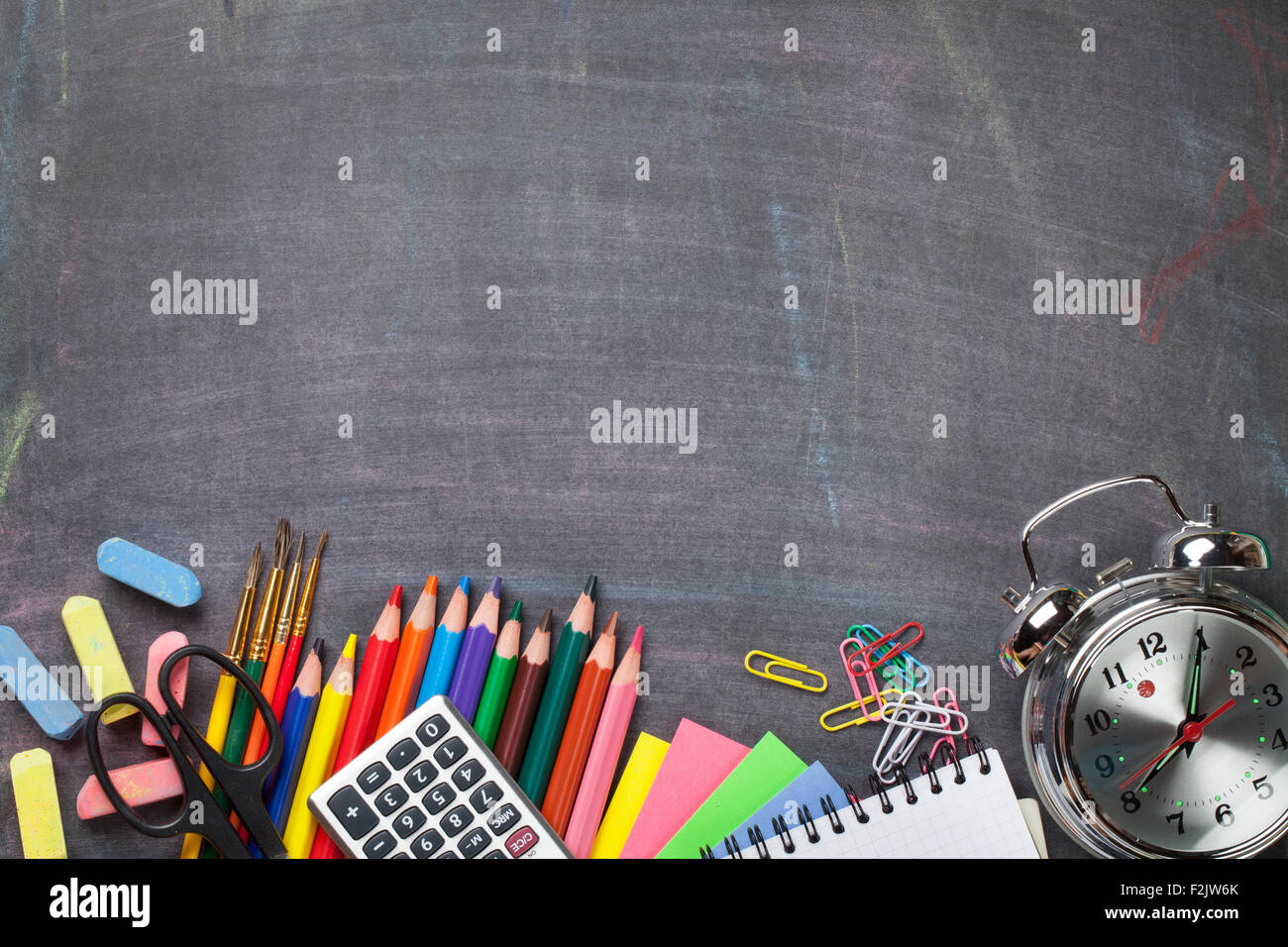 School and office supplies on blackboard background. Top view with copy ...