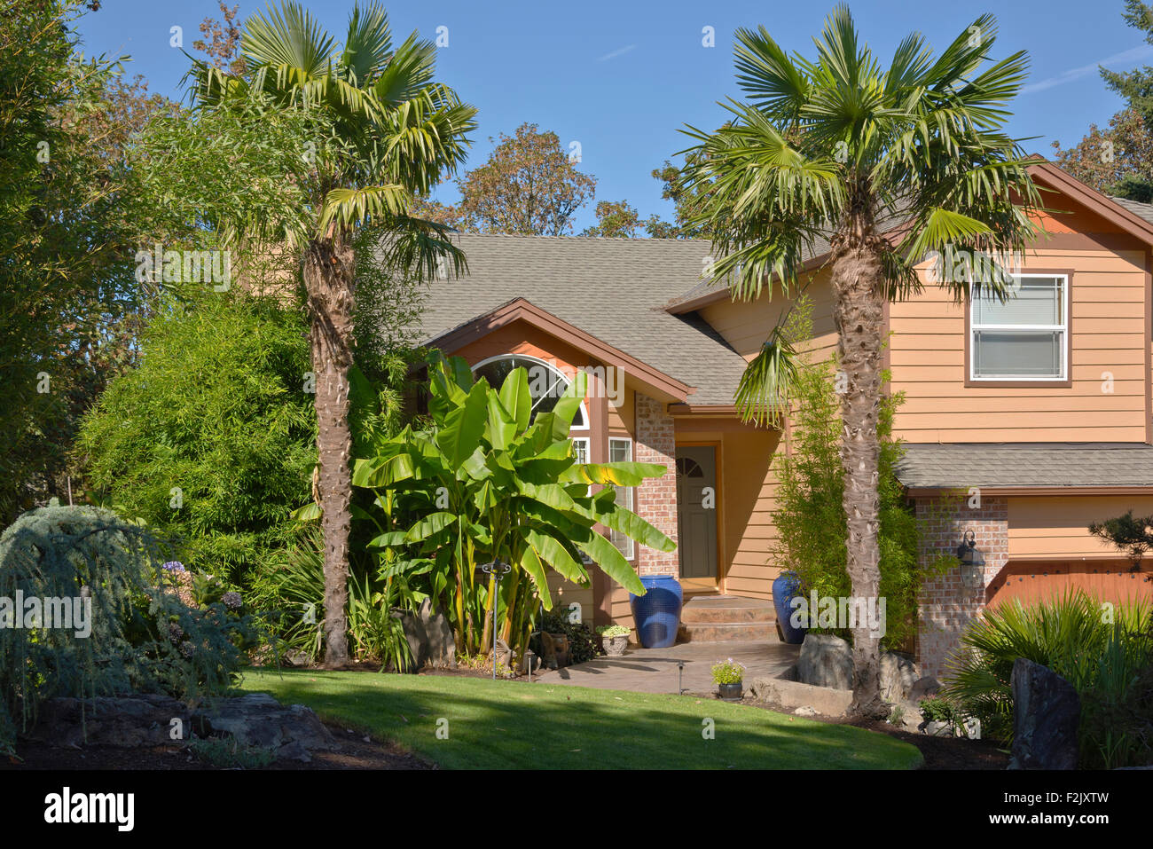 Tropical house with banana and palm trees Oregon Stock Photo Alamy